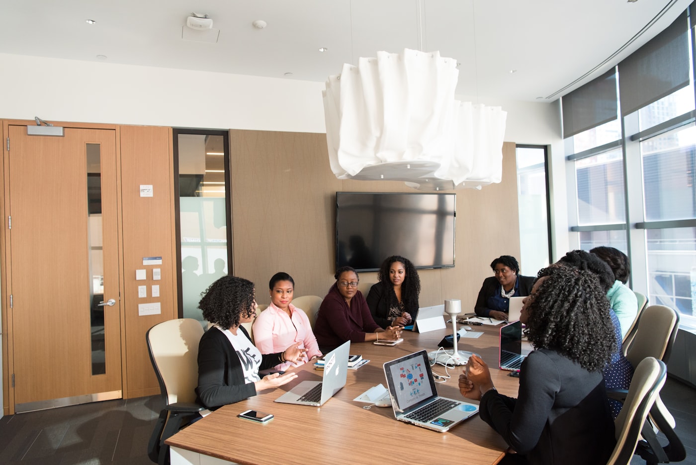 An agent giving clients superb service in a bright, modern office